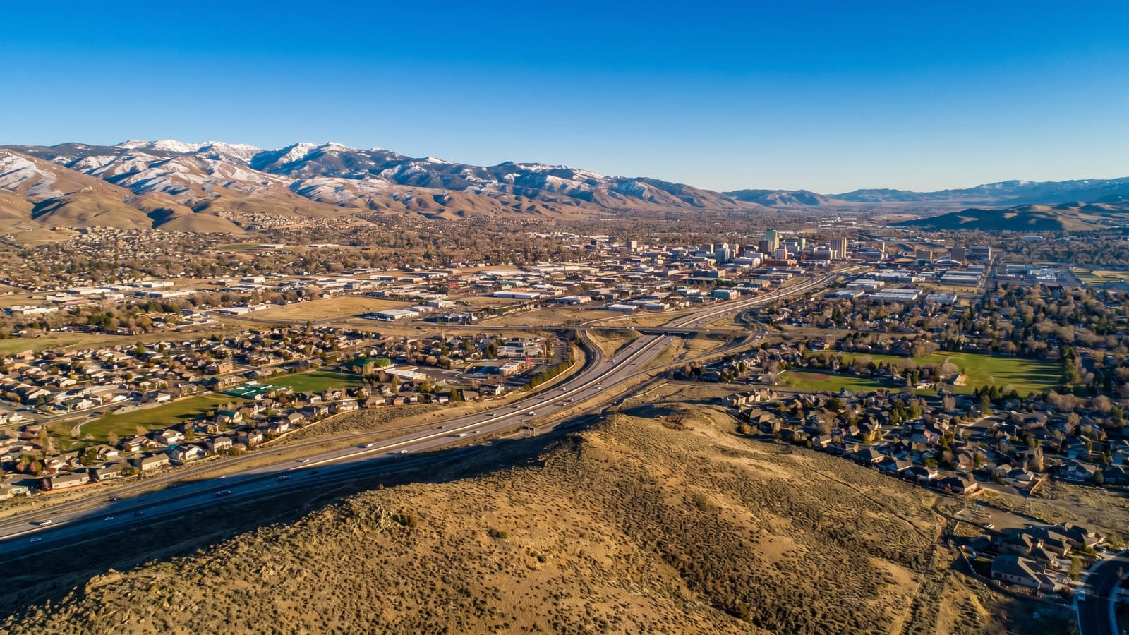 Aerial of the Truckee Meadows valley with Reno and Sparks, Nevada spread below the Sierra Nevada foothills